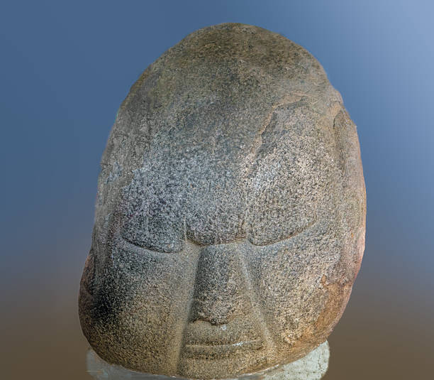 Moving expression on a  colossal head rock sculpture extracted among the ruins of an ancient Olmec settlement in the Pacific Coast of Guatemala