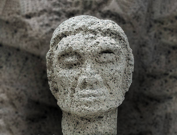 istock Hypnotizing colossal head rock sculpture extracted among the ruins of an ancient Olmec settlement in the Pacific Coast of Guatemala 2203444643