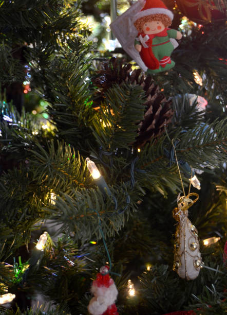 istock Christmas tree evergreen with ornaments lights and pinecone background 2203445769