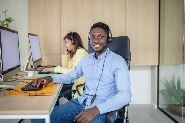 istock Young professionals engage in customer support at a modern call center focused on real estate assistance 2203447324