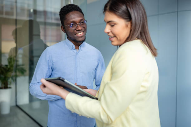 istock Young professionals engaged in a collaborative discussion about business strategies in a modern office environment 2203447493