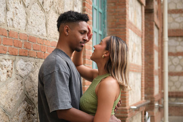 istock Young multi-ethnic couple embracing and looking at each other with love 2203448419