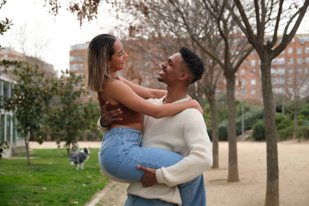 istock Happy young couple having fun in a park 2203448805