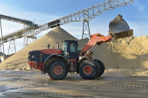 istock Gravel pit: building and wheel loader loading gravel onto a truck 2203449638