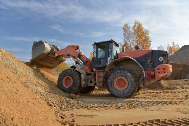istock Gravel pit: building and wheel loader loading gravel onto a truck 2203449677