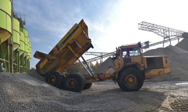 istock Gravel pit: building and wheel loader loading gravel onto a truck 2203449726