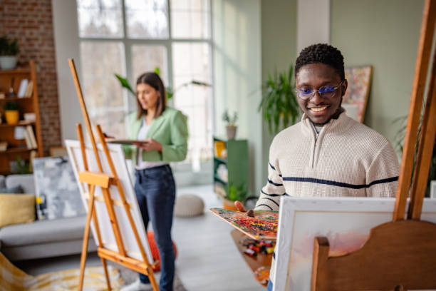 istock Creative young adults express artistic skills in a vibrant art studio environment 2203449733