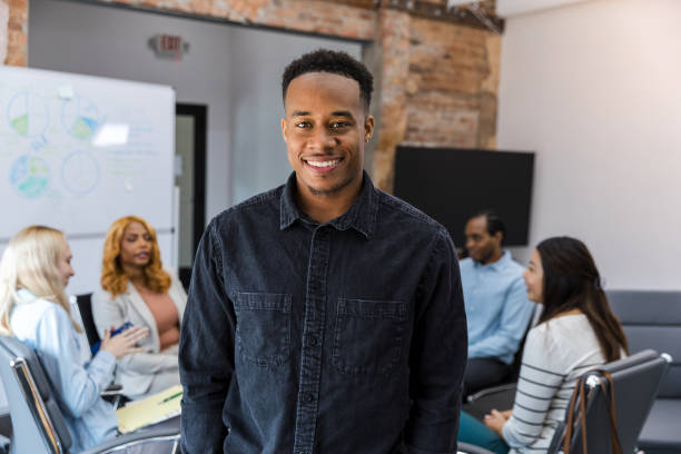 istock Confident young man smiling during a business meeting 2203450038