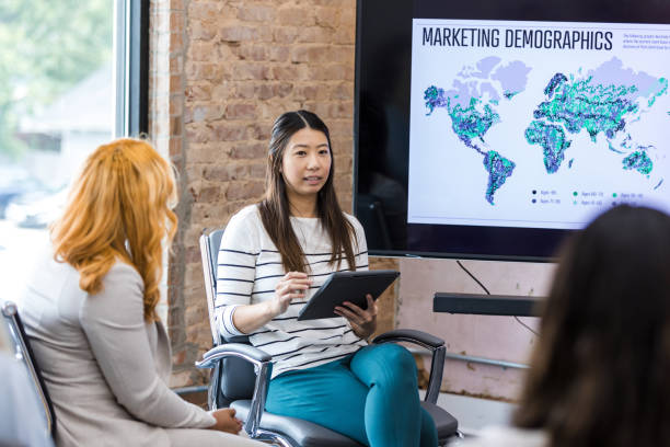 istock Asian Woman Giving Presentation Using Tablet, Marketing Meeting 2203450043