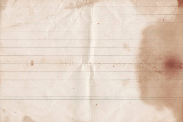 Folded old notebook paper texture. Brown notebook stained paper sheet background with space for text. Vintage worn paper texture