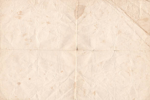crumpled old paper texture background. brown folded parchment vintage paper sheet with space for text - overstuur fotos stockfoto's en -beelden