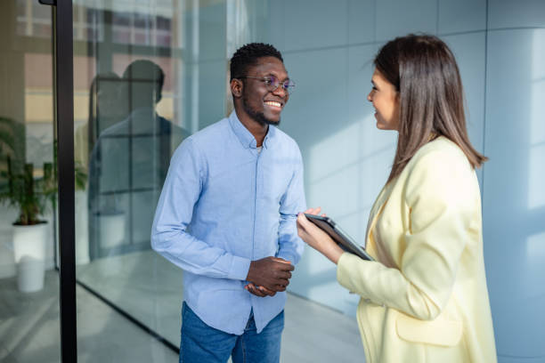 istock Engaging conversation between colleagues in a modern office setting focusing on teamwork and collaboration 2203450663