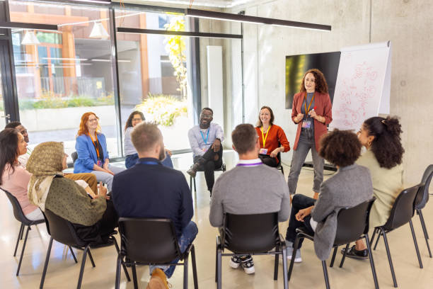 istock Businesswoman presenting ideas to diverse group using flipchart 2203451296