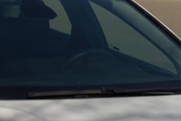 istock Close up of a car windshield with a steering wheel behind 2203452719