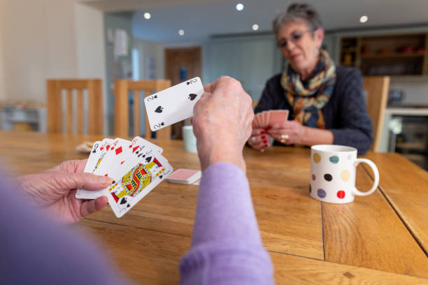 istock Friends Playing Cards with a Cup of Tea 2203454707