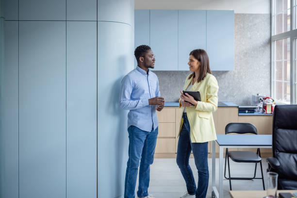 istock Professional discussion between colleagues in a modern office setting focusing on teamwork and collaboration 2203455235