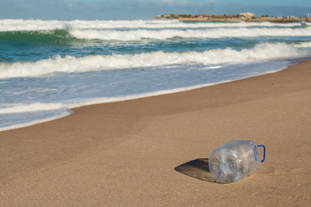trash, plastic cups and plastic bags at the beach. environmental problem concept and healing the world