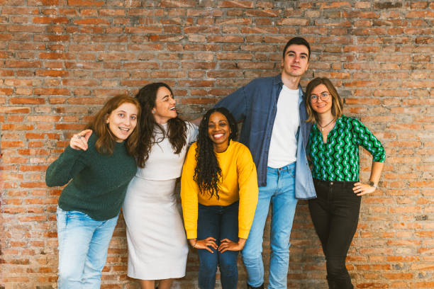istock Cheerful team of professionals posing together at work 2203456123