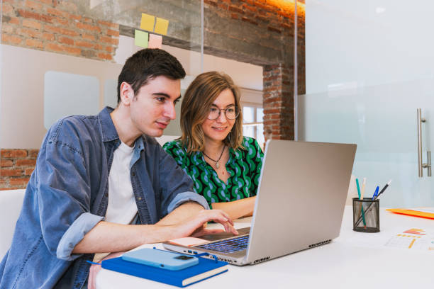 istock Focused Teamwork on a Laptop in a Modern Office 2203456431