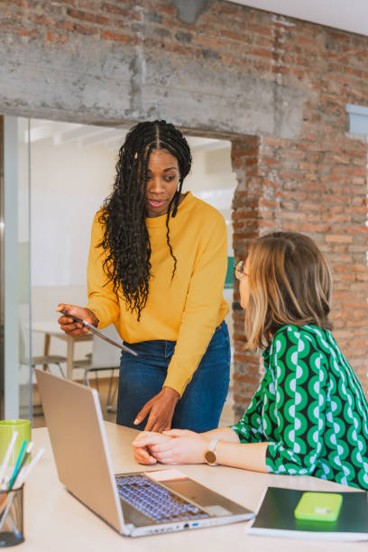 istock Two Businesswomen Collaborating in a Modern Office 2203456593
