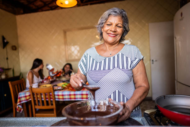 istock Senior woman melting chocolate at home 2203456913