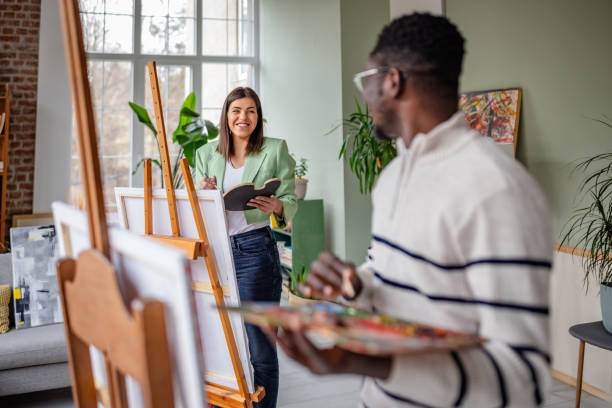 istock Young artists collaborate and share ideas in an inspiring art studio environment 2203457595