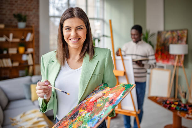 istock Young artists collaborate in a lively art studio, sharing creativity and inspiration through their vibrant paintings and engaging activities 2203457999