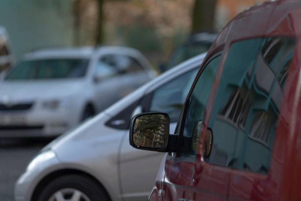 istock A red van is parked next to a white van in a busy lot 2203459532