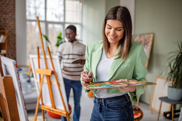 istock Young artists engage creatively in a vibrant art studio filled with inspiration and collaboration 2203459633