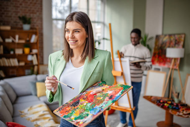 istock Young artists engage in creative activities at a vibrant art studio while learning and collaborating with each other 2203459835