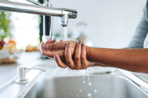 istock washing hands at the tap at home 2203460633