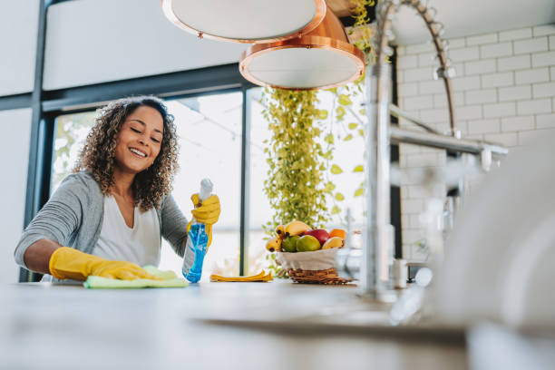 istock A woman cleans the kitchen counter 2203460647