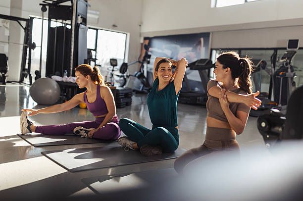 Friends warming up together in a gym before a workout session