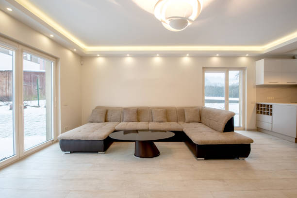 istock Modern Living Room With Spacious Sofa and Large Windows Overlooking Outdoor Snow View 2203462632