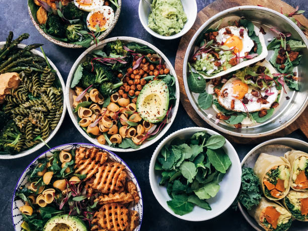 A selection of vegetarian dishes, such as sweet potato burritos, French fries, and sweet potato bowls.