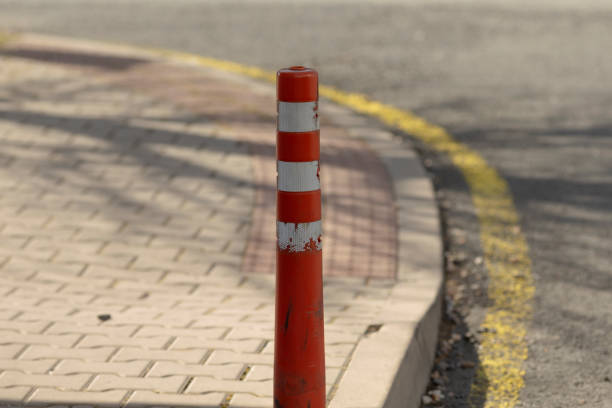 istock There is a red and white colored pole located on the roadside area 2203469141