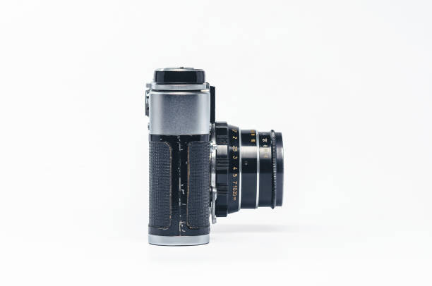 istock Classic silver and black film camera side profile on white backdrop 2203471645