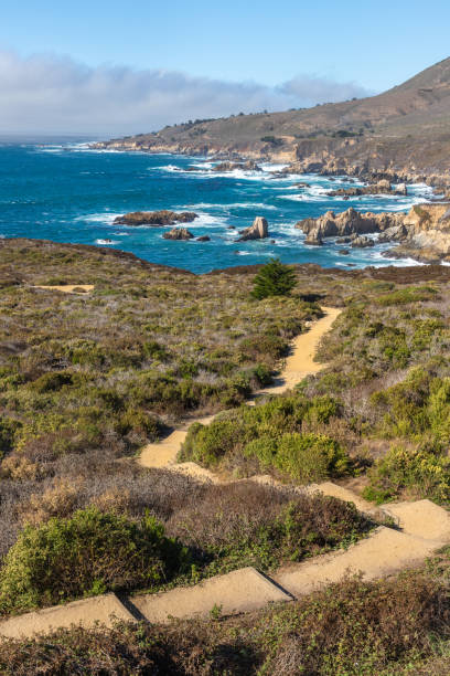 istock Coast trail with vegetation and mountains 2203480314