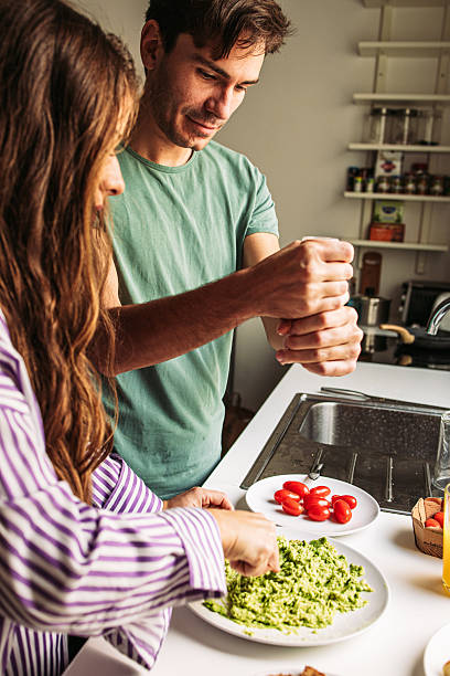 istock Man seasoning avocado for breakfast 2203480764