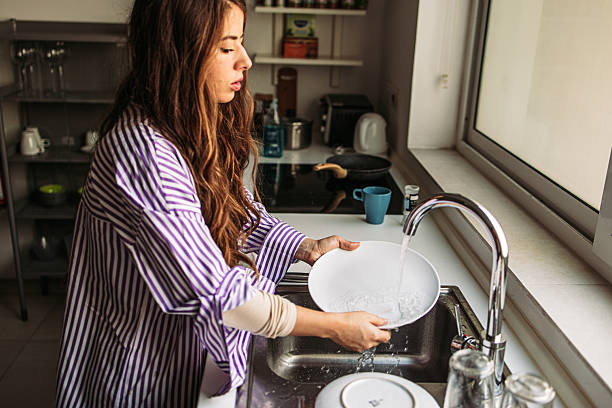 istock Cleaning up after breakfast in a bright kitchen 2203481874