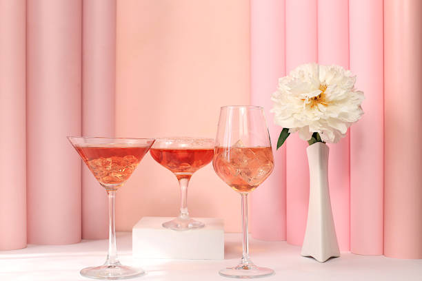 istock Festive alcoholic cocktail Spritz, red Martini, tequila in glasses on a bright background with a bouquet of peonies, summer bar concept, alcoholic drinks at a party, restaurant and cafe advertising, selective focus. 2203483670