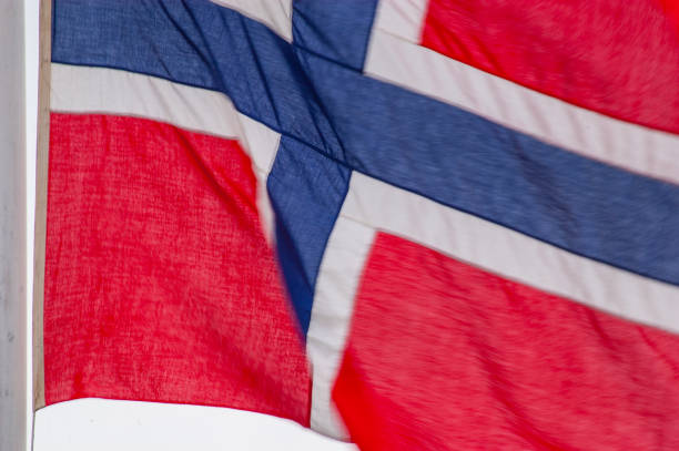 istock norwegian flag waving in the wind, close-up shot.. 2203484407