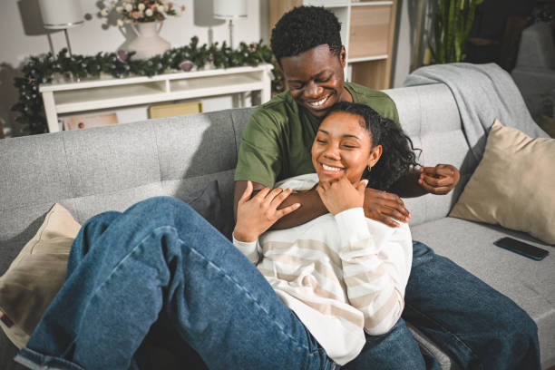 istock young couple on a date, sitting on the couch 2203484431