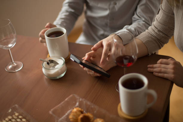 istock A couple enjoys coffee and dessert while interacting with their phones 2203487888