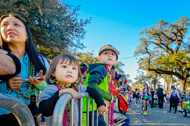 Mobile, Alabama, USA - Feb. 7, 2016: A family watches the Joe Cain Day Mardi Gras parade in Mobile, Alabama.