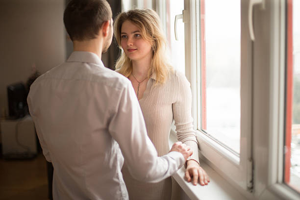 istock A couple engaging in a warm interaction by a window in a bright indoor space 2203489085