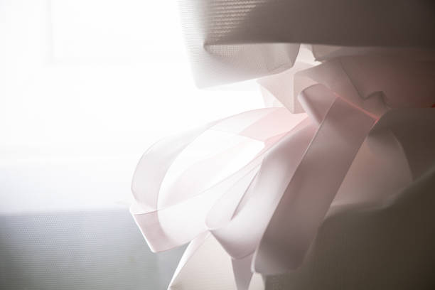 Flower wrap white with pink ribbon and bow on bouquet as background,flower wrap