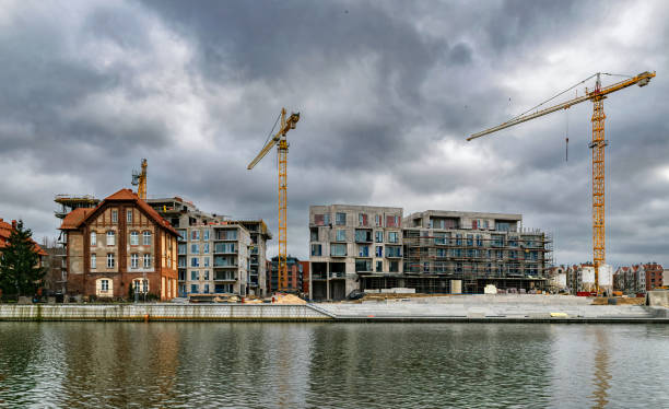 istock New house construction in the old town. Concrete frame and cranes 2203492635