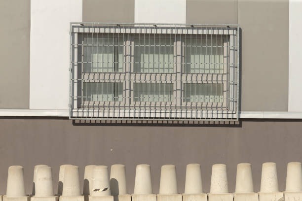 This is a structure featuring a window along with a fence situated directly in front of it, enhancing the overall design appeal
