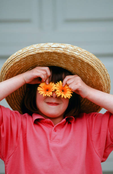 istock Young child enjoying wearing a BIG hat 2203495022